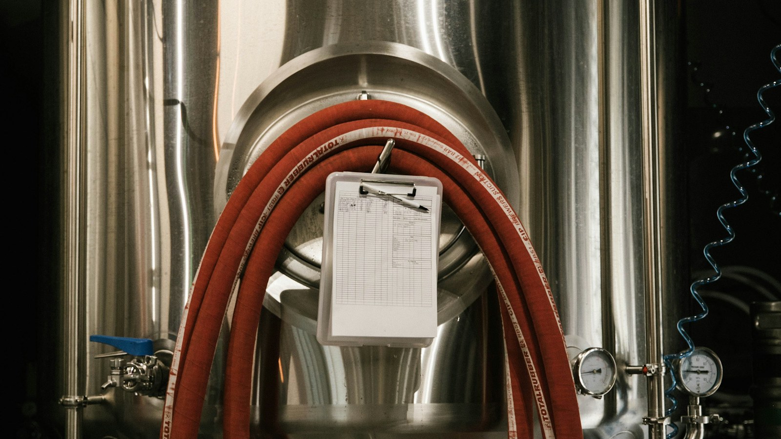 Stainless steel tanks inside a craft brewery, representative stock photography